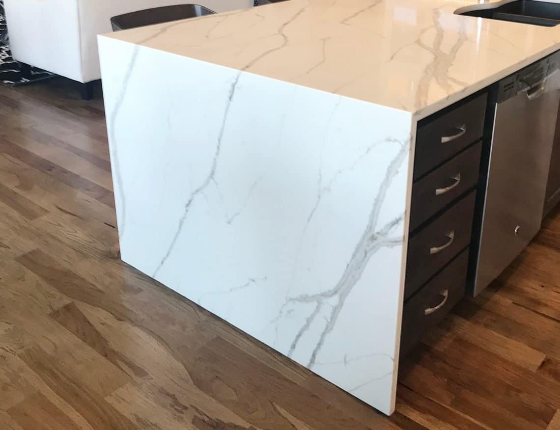 kitchen waterfall island quartz countertop and hardwood floors