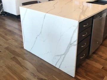 kitchen waterfall island quartz countertop and hardwood floors