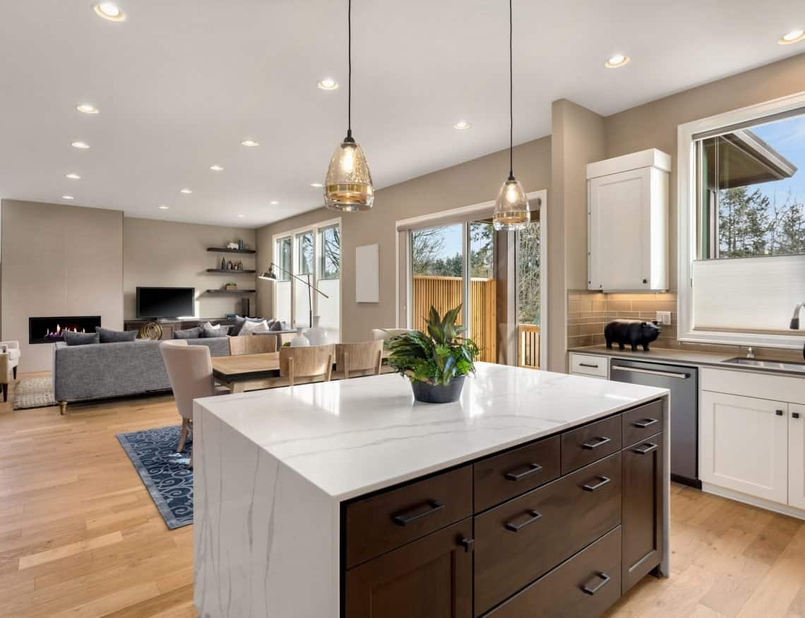 Stunning kitchen and living room in new luxury home with quartz countertop