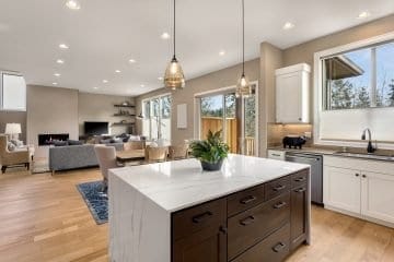 Stunning kitchen and living room in new luxury home with quartz countertop